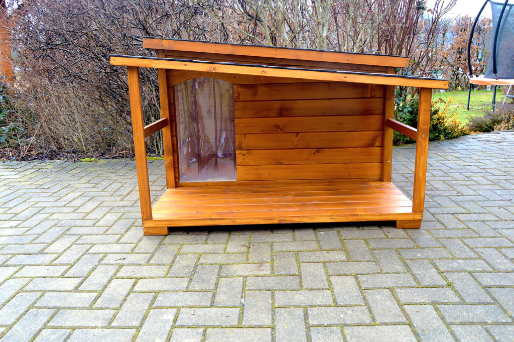 Psia búda DINO so šikmou strechou a praktickou krytou terasou vo svetlohnedom odtieni dub, s červenohnedou krytinou a vchodom prekrytým tepelnou clonou #3